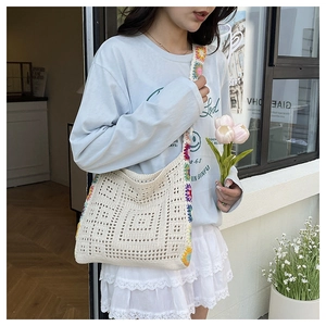 Detailed knit pattern on beige hollow-out bucket bag with bohemian floral shoulder strap