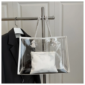 Detail of transparent PVC tote with white leather trim and sturdy thick rope handles
