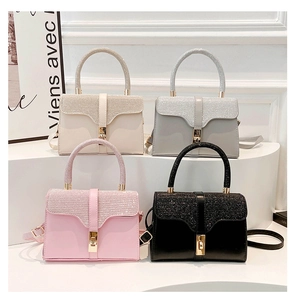 Chic handbags in four colors featuring sparkly glitter handles and metal twist lock