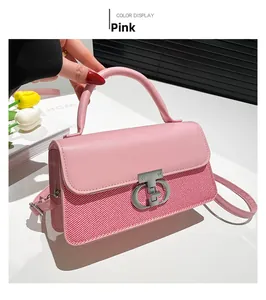 Detail of pink patchwork handbag featuring T-shaped metal twist lock and woven texture