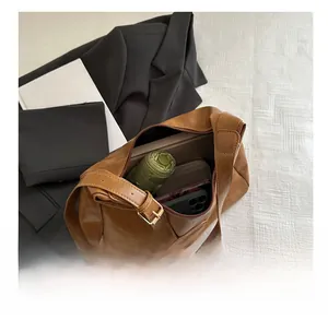 Interior view of the brown leather tote bag showing large capacity for umbrella and wallet
