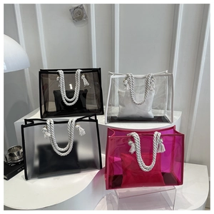 Detail of colorful PVC tote bags with thick cotton rope handles in four different colors