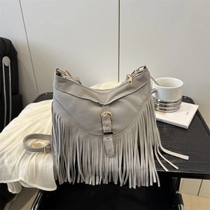 Vintage grey fringe crossbody bag with matte suede finish and gold buckle detail