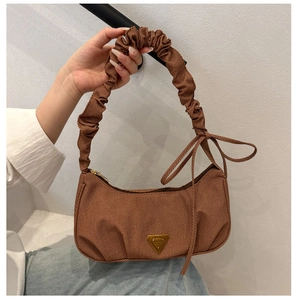 Brown pleated crescent bag with a decorative bow and gold triangular metal logo