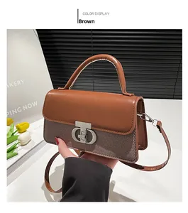 Detail of a brown leather and fabric handbag with a silver metal clasp and round handle