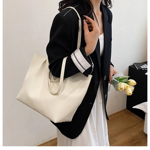 Minimalist beige tote bag shoulder strap and premium leather detail in a professional setting