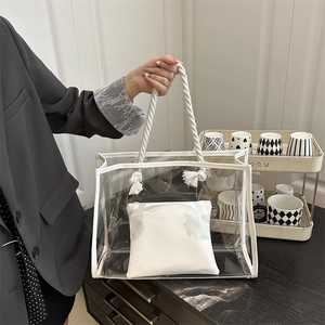 Minimalist clear PVC tote bag with white cotton rope handles and inner pouch