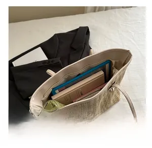Interior view of the large straw tote bag showing capacity for tablets and essentials