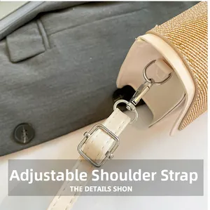 Detail of beige woven bag showing adjustable leather shoulder strap and silver metal buckle