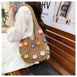 Detailed view of handmade hollow knit tote bag with colorful 3D floral accents
