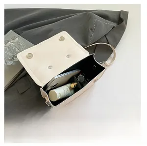 Interior view of the cream square crossbody bag showing large capacity for essentials