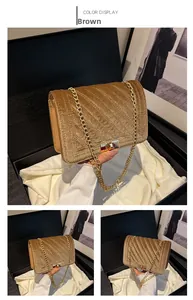 Detail of brown velvet crossbody bag with V-shaped quilting and gold chain strap