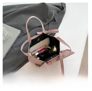 Internal capacity of pink nylon bow handbag with smartphone and cosmetic items