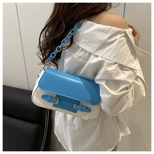 Detail of blue and white color-block handbag with resin and gold metal chain strap
