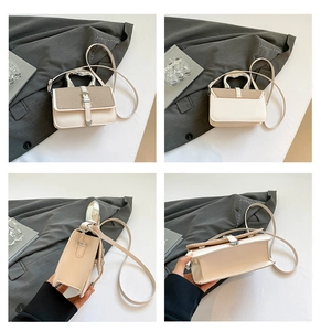 Detail view of contrast color bag with heart-shaped handle and woven texture texture
