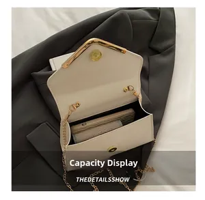 Detail show of cream envelope clutch bag interior capacity for phone and wallet
