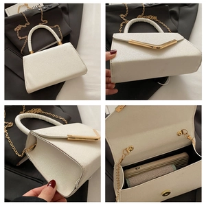 Detail view of white glitter handbag with gold V-trim, chain strap and internal space