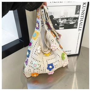 Detailed close-up of handmade crochet tote bag with colorful 3D floral embroidery