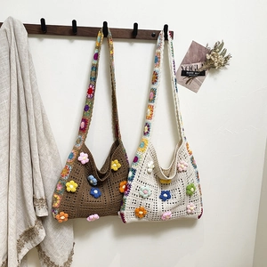 Handmade crochet tote bag with 3D floral patterns and colorful granny square straps