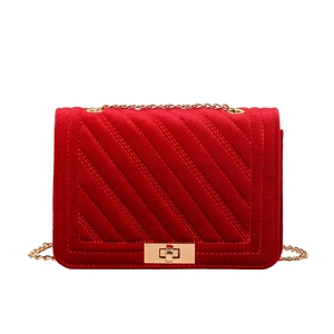Red quilted velvet crossbody bag with elegant gold chain strap and metal lock