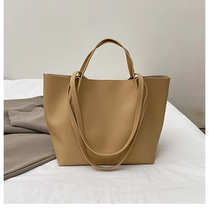 Detail showing the fine matte texture and soft sheen of the khaki tote bag material