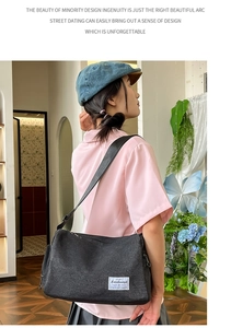 Detailed view of the large black nylon crossbody bag with adjustable wide strap