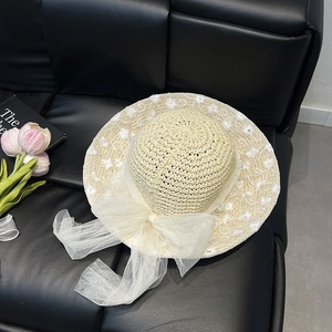Minimalist summer straw hat with white lace bow and pearl floral embroidery details
