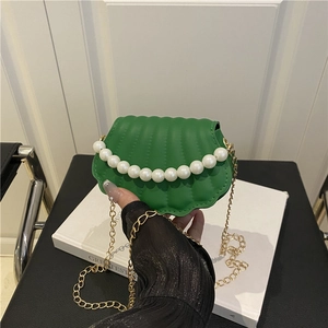 Shell-shaped mini shoulder bag in bright green PU leather with a large pearl handle strap