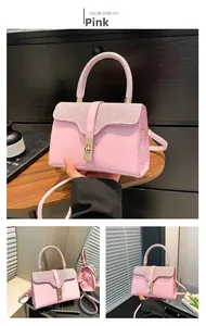 Detailed macro view of pink handbag featuring sparkling crystal-encrusted handle and gold lock