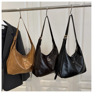 Hanging set of vintage Hobo bags in tan, dark brown and black with golden hardware