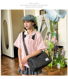 Detail of a minimalist black canvas crossbody bag styled with a casual school outfit