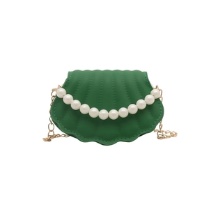 Green shell-shaped crossbody bag with pearl handle and golden chain strap