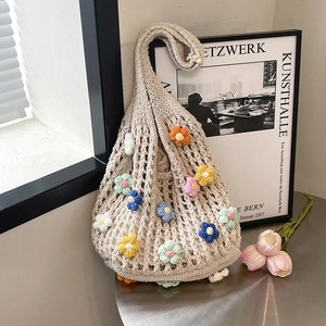 Handmade crochet tote bag featuring colorful 3D flowers and a cream woven mesh design