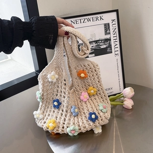 Handcrafted crochet tote bag with colorful 3D floral accents and summer hollow design