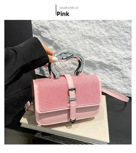 Detail of pink candy color handbag with silver streamlined handle and textured fabric
