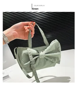 Detail of mint green nylon handbag with large bow design and textured fabric