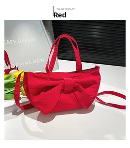 Detail view of the large red fabric bow design on this stylish shoulder and crossbody bag
