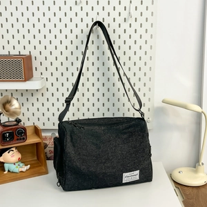 Black canvas crossbody bag for men and women with adjustable strap and logo detail