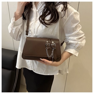 Detail of vintage brown baguette bag with silver buckle and metallic chain strap
