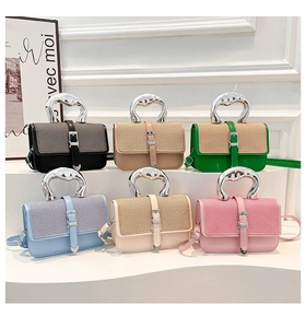 Detail view of colorful square bags with metallic lava-style handles and premium PU texture