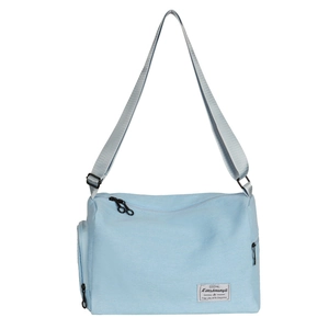 Minimalist light blue canvas crossbody bag with adjustable strap and multi-pocket design