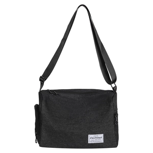 Minimalist black canvas crossbody bag with adjustable strap and brand woven label