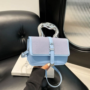 Chic light blue crossbody bag with wave metal handle and woven leather texture detail