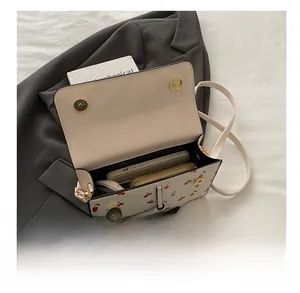 Detail view of the cherry print crossbody bag showing interior storage capacity