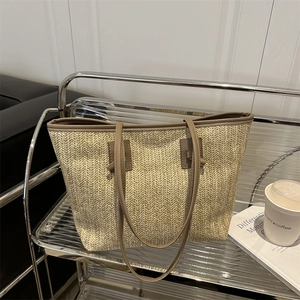 Large straw tote bag with brown leather handles for summer beach and daily commute