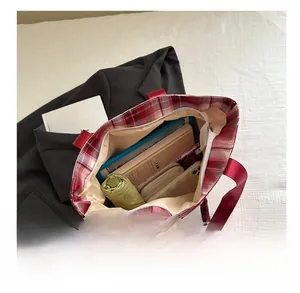 Top view of red plaid tote bag interior showing large capacity for tablet and umbrella