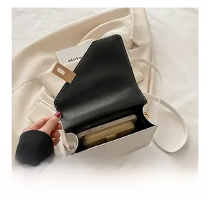 Internal capacity of the white leather crossbody bag showing space for phone and wallet