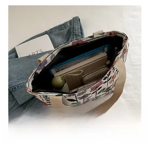 Spacious floral canvas tote bag showing interior capacity with tablet and daily essentials