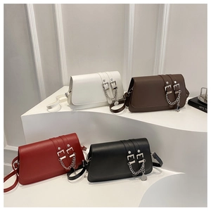 Group display of four baguette bags in white, brown, red, and black with belt buckles
