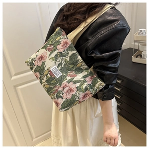 Detail of floral jacquard tote bag with vintage embroidery on a shoulder strap